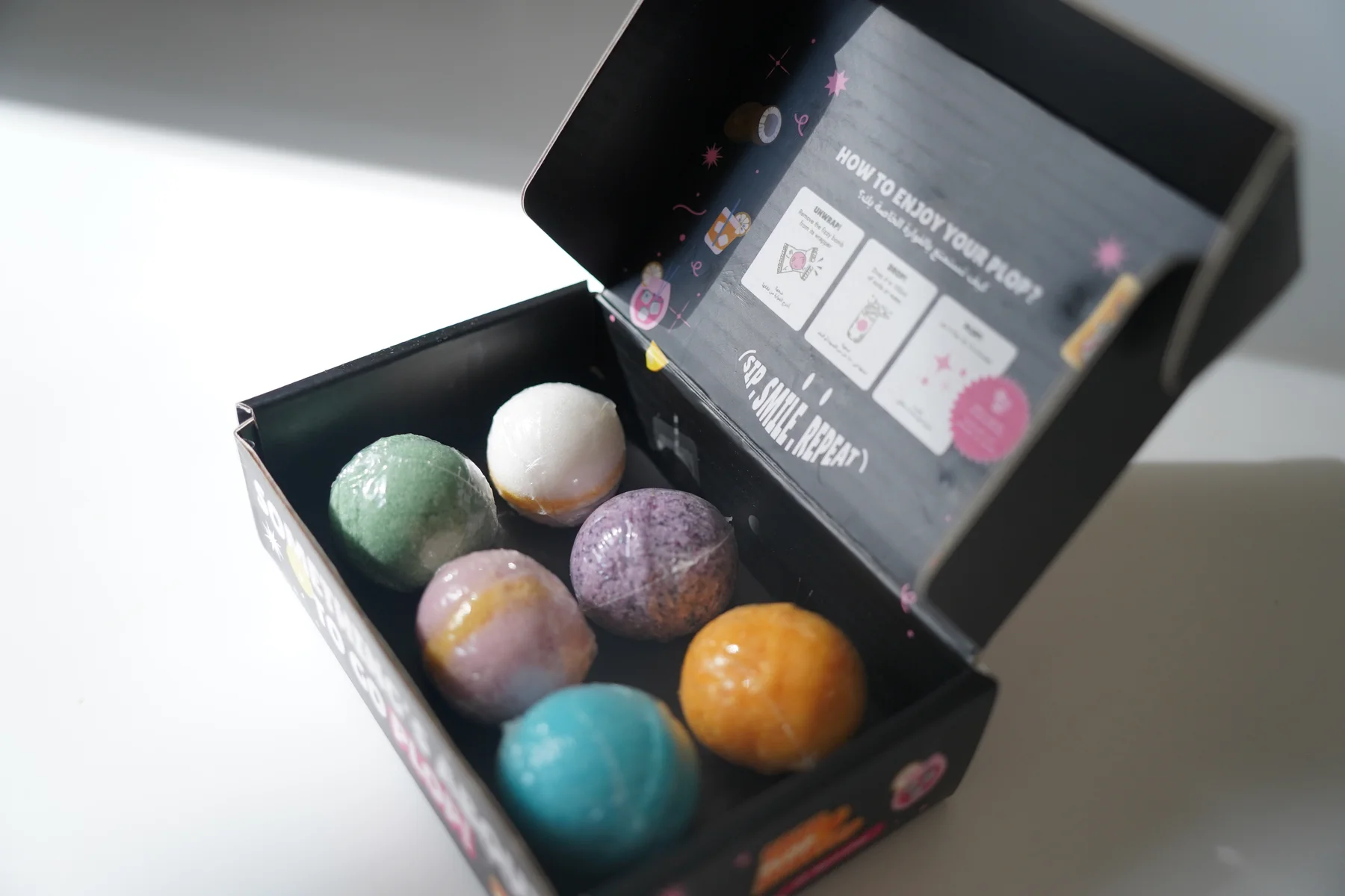 Open Plop mixed box with colourful drink bombs and branded packaging